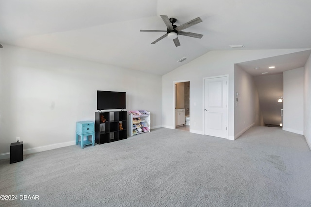 interior space featuring light colored carpet, ceiling fan, and vaulted ceiling