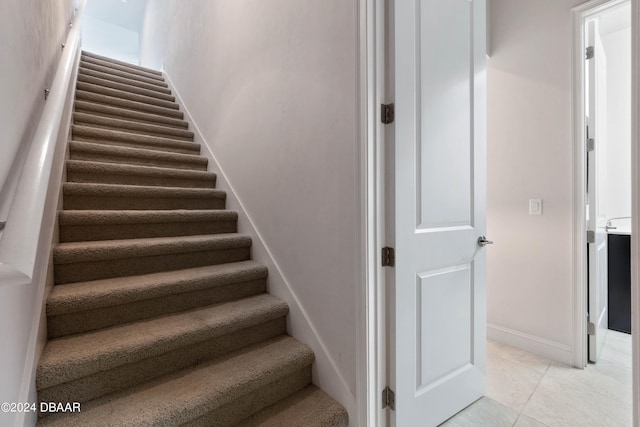 stairway with tile patterned flooring