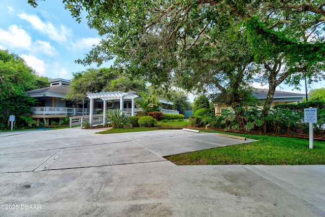 surrounding community featuring a pergola and a yard