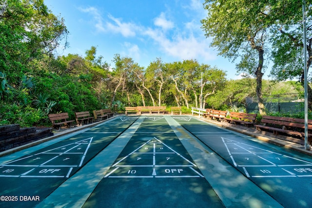 view of home's community featuring shuffleboard and fence