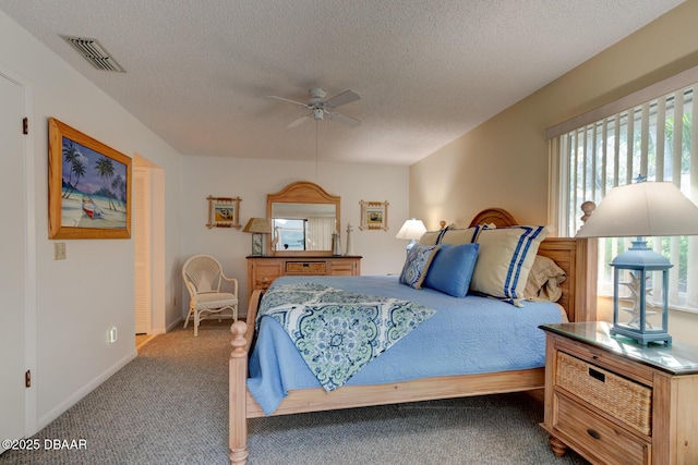 bedroom with carpet floors, visible vents, a ceiling fan, a textured ceiling, and baseboards