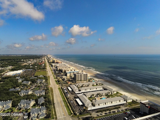 birds eye view of property featuring a beach view and a water view