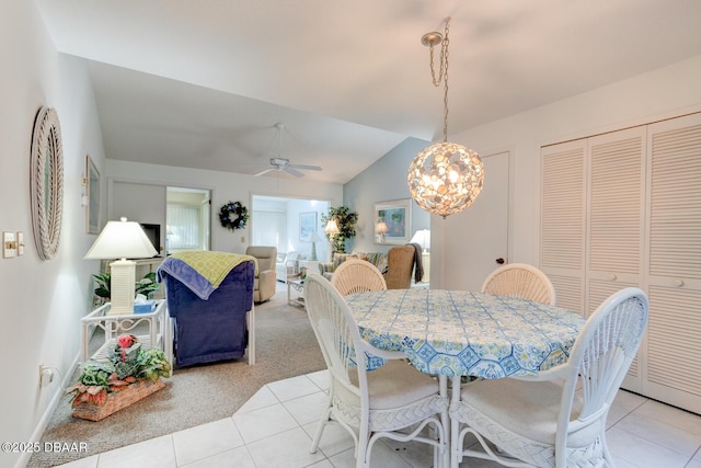 dining area featuring lofted ceiling, light tile patterned floors, light carpet, and a ceiling fan