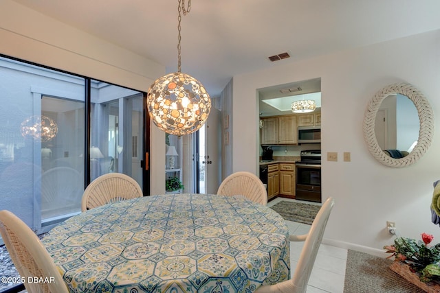 dining room with light tile patterned floors, visible vents, and baseboards