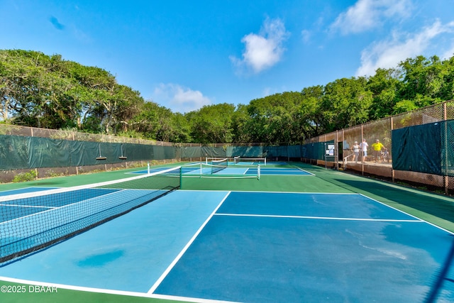 view of tennis court with fence