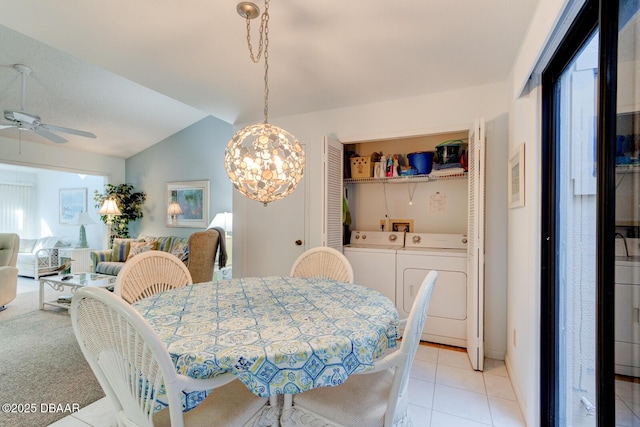 dining room featuring a ceiling fan, washer and dryer, a healthy amount of sunlight, and vaulted ceiling