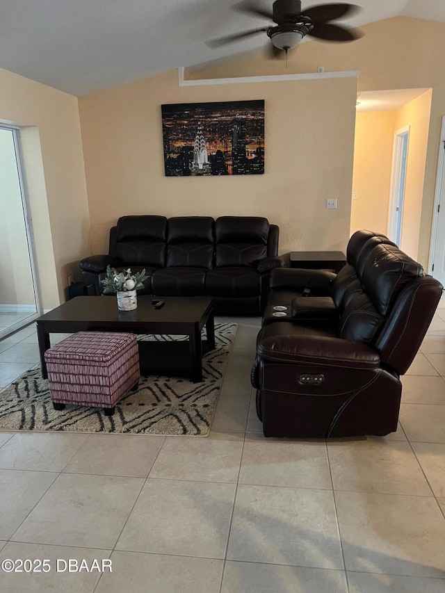 living room featuring tile patterned floors, ceiling fan, and vaulted ceiling