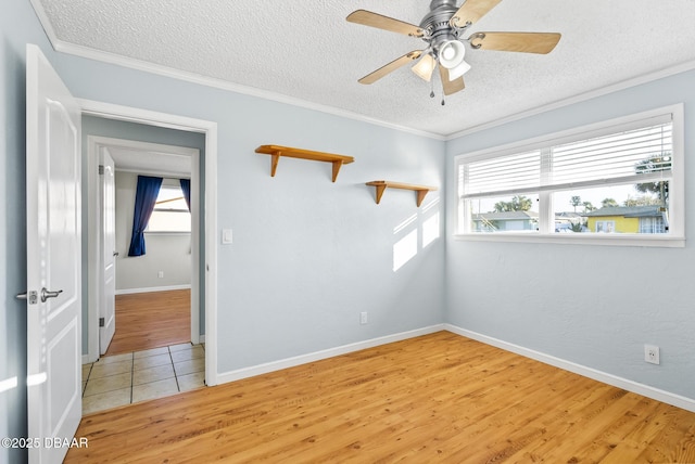 unfurnished room with ceiling fan, crown molding, a textured ceiling, and hardwood / wood-style flooring