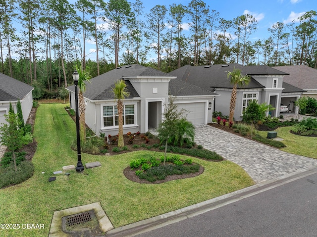 view of front of home with a front yard and a garage