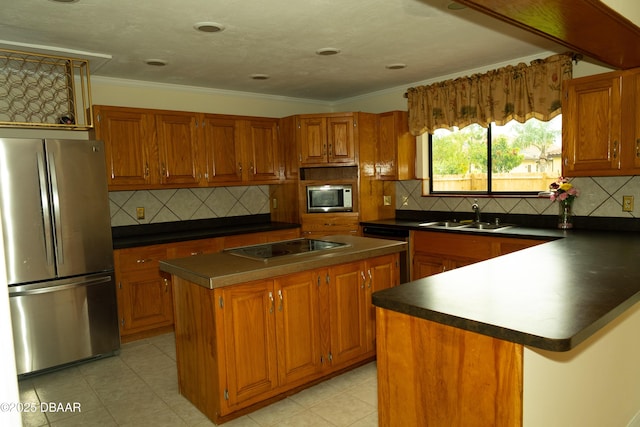 829 N Beach St, Ormond Beach, FL 32174 - kitchen featuring appliances with stainless steel finishes, dark countertops, brown cabinets, a center island, and ornamental molding
