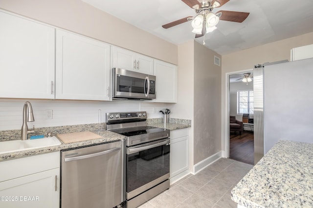 kitchen featuring visible vents, white cabinets, ceiling fan, appliances with stainless steel finishes, and a sink