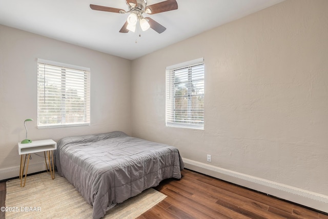 bedroom featuring light wood-style flooring, baseboards, and ceiling fan