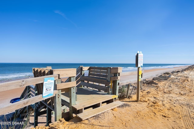 view of community featuring a beach view and a water view