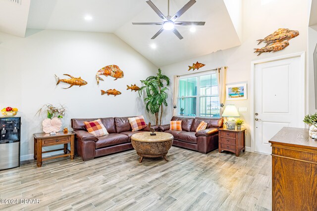 living room featuring ceiling fan, light wood-type flooring, and high vaulted ceiling