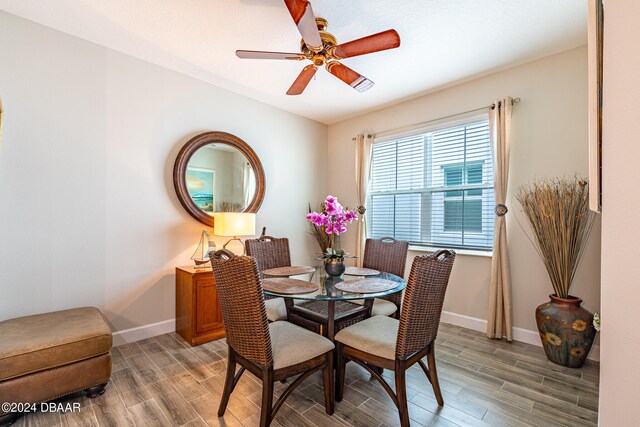 dining room with hardwood / wood-style flooring and ceiling fan