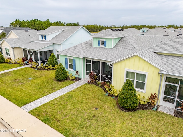 view of front of house featuring a front yard and a sunroom