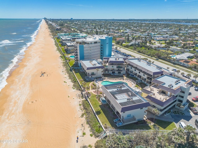 bird's eye view featuring a water view and a beach view