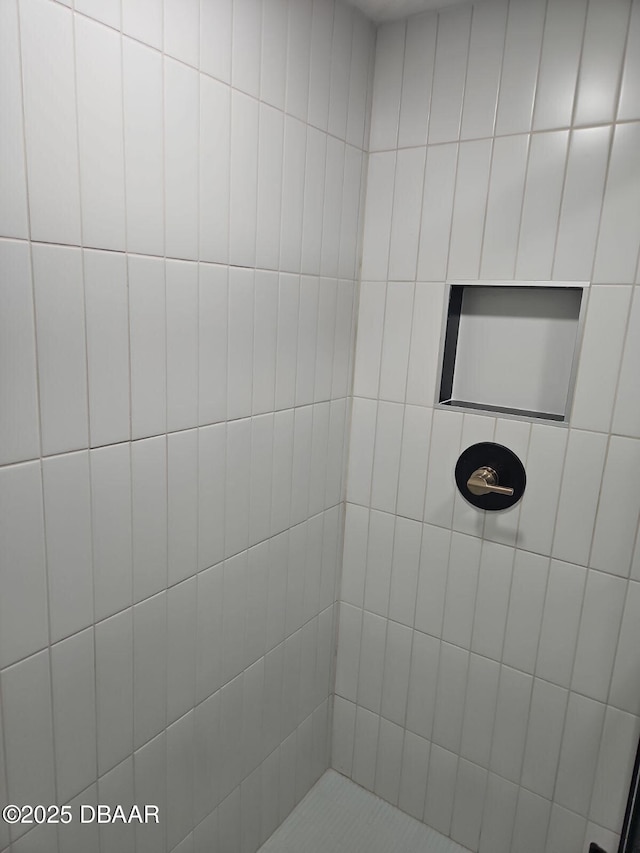 full bath featuring a tile shower