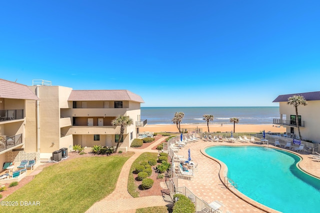 pool with a water view, central AC unit, and a patio area