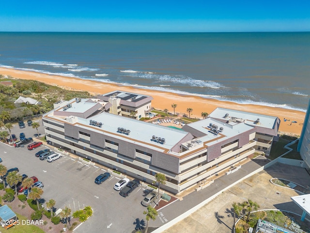 drone / aerial view featuring a water view and a view of the beach