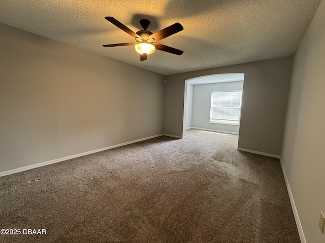 spare room with ceiling fan, carpet, and a textured ceiling