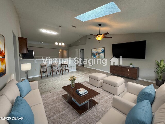 kitchen with sink, stainless steel appliances, kitchen peninsula, vaulted ceiling, and decorative light fixtures