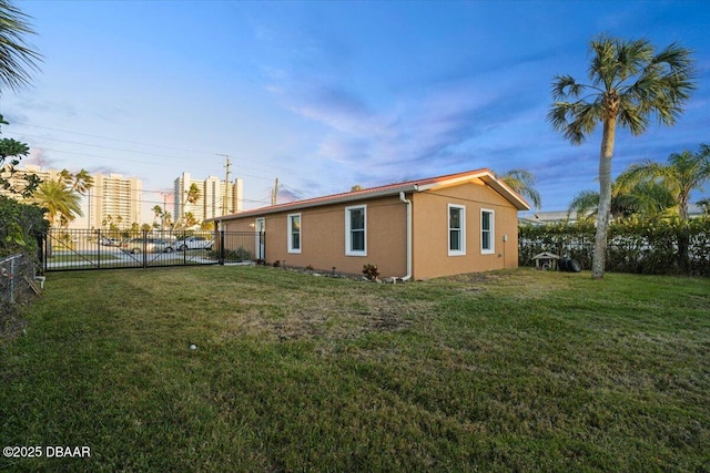 view of side of home featuring a yard