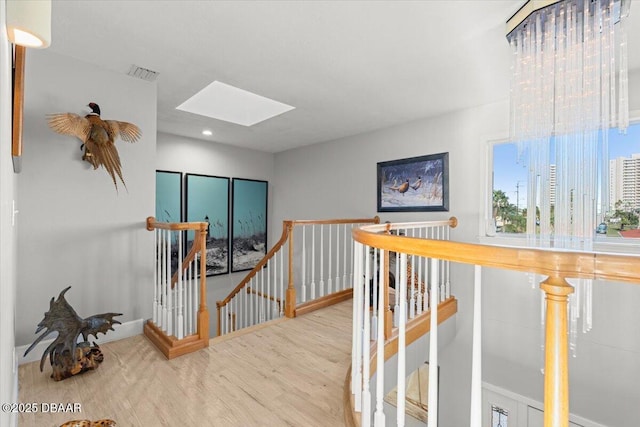 hall featuring a skylight and hardwood / wood-style floors