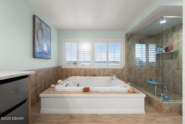 bathroom featuring separate shower and tub and vanity