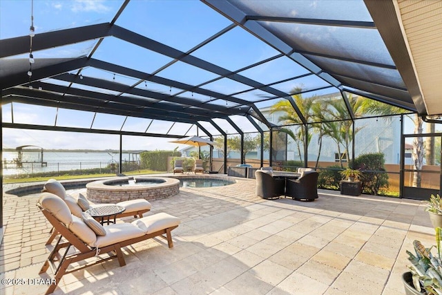 view of patio featuring a water view, a pool with hot tub, and glass enclosure