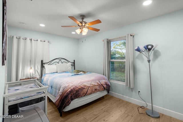 bedroom with ceiling fan and light hardwood / wood-style floors