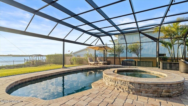 view of swimming pool featuring glass enclosure, a water view, an in ground hot tub, and a patio