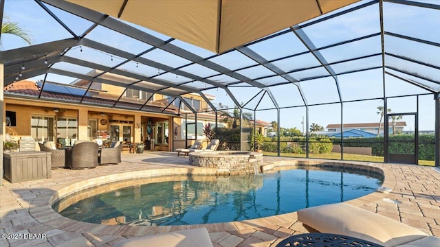 view of pool featuring glass enclosure, a patio area, an in ground hot tub, ceiling fan, and an outdoor living space