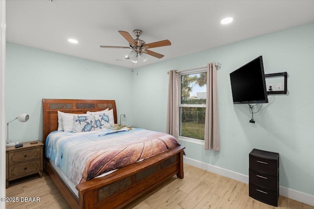 bedroom with ceiling fan and light hardwood / wood-style flooring