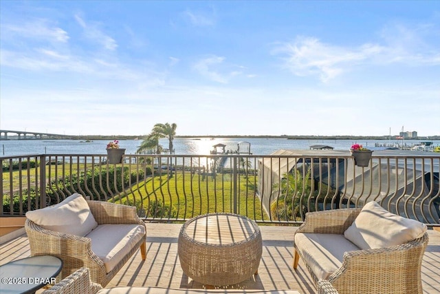 wooden terrace featuring a water view