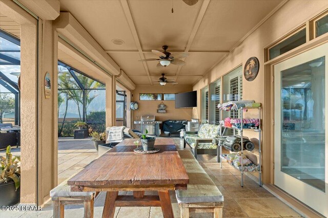 sunroom featuring ceiling fan