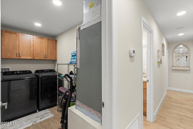 washroom with light wood-type flooring and separate washer and dryer