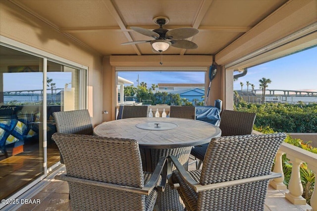 exterior space with ceiling fan, a wealth of natural light, and coffered ceiling