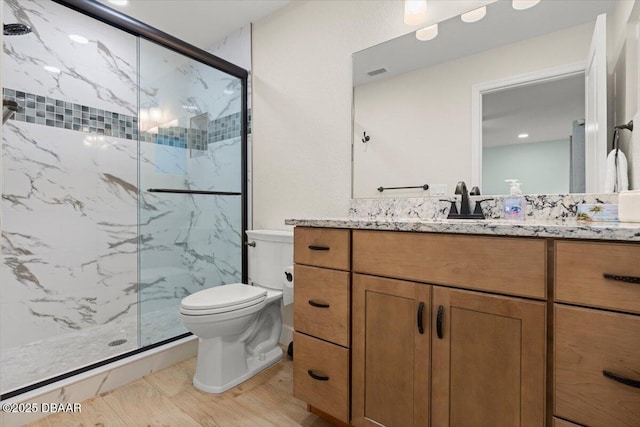 bathroom featuring vanity, toilet, and walk in shower