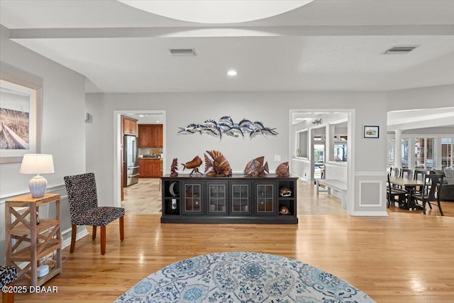 interior space featuring light hardwood / wood-style flooring and decorative columns