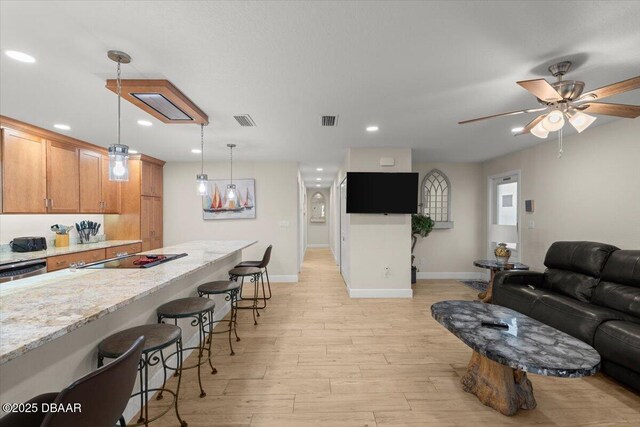 living room with light wood-type flooring and ceiling fan