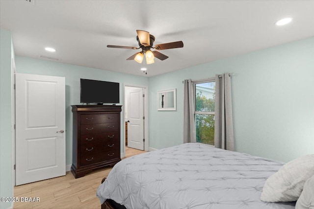 bedroom with ceiling fan and light hardwood / wood-style flooring