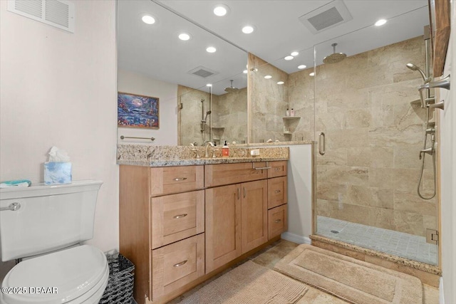 bathroom featuring vanity, toilet, and walk in shower