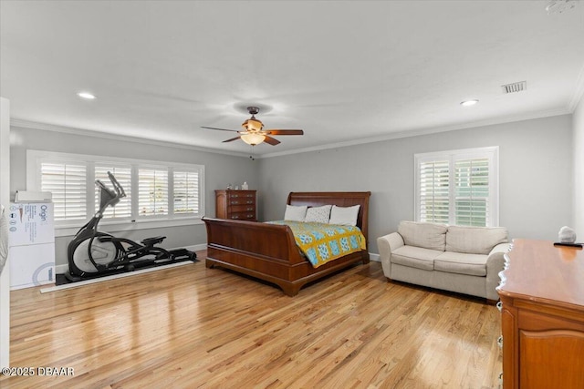 bedroom featuring ceiling fan, light hardwood / wood-style floors, and ornamental molding