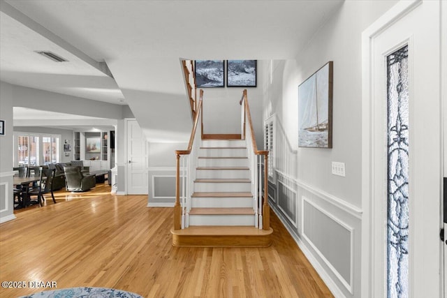 stairway with hardwood / wood-style flooring