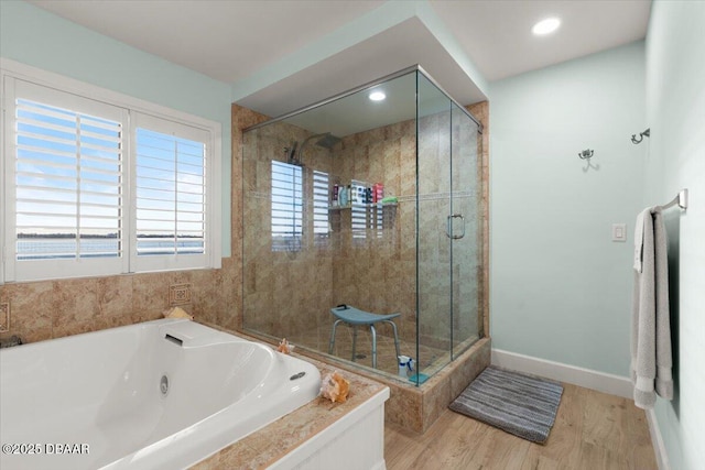 bathroom featuring plus walk in shower and wood-type flooring