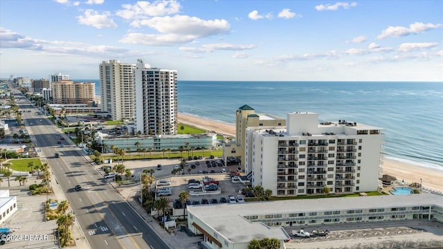 drone / aerial view with a water view and a beach view