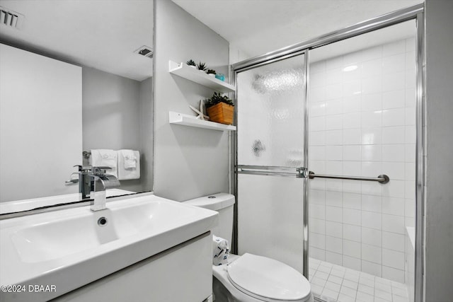 bathroom with vanity, toilet, and a shower with shower door