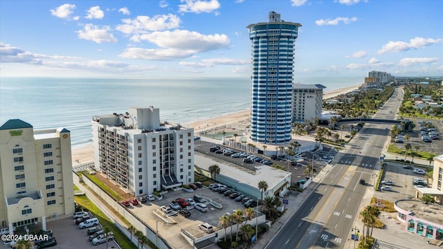 drone / aerial view featuring a water view and a view of the beach