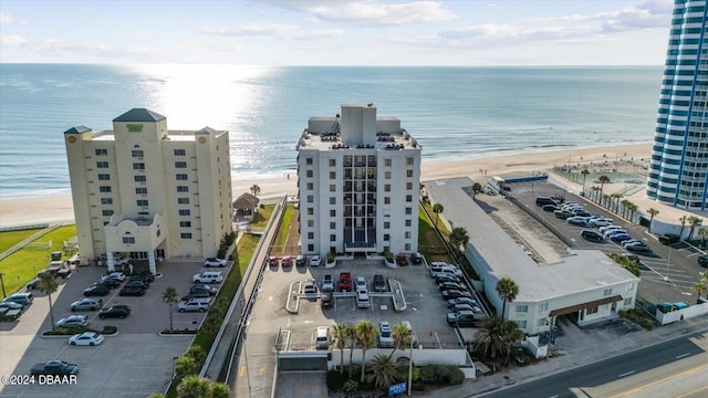 birds eye view of property featuring a water view and a beach view